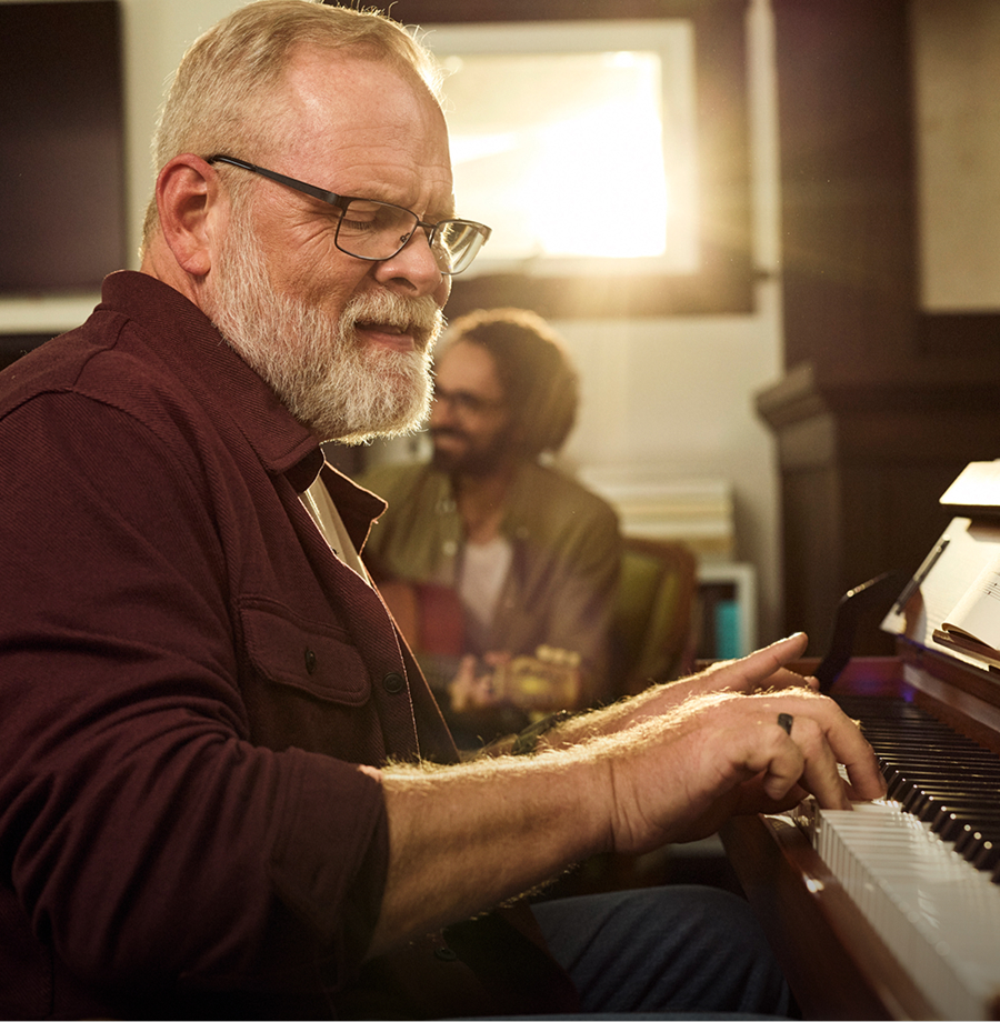 An older man playing piano.